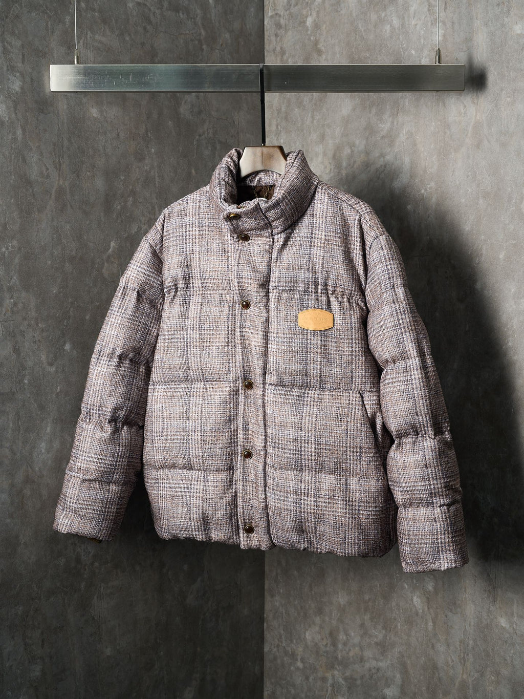 Louis Vuitton long puffer jacket front view with chest logo patch and button tabs