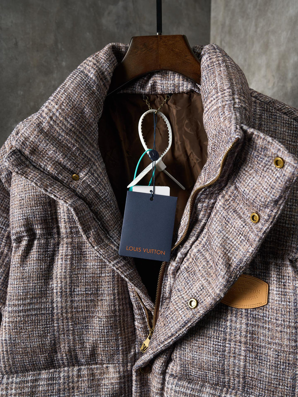 Louis Vuitton long puffer jacket with hood lining and front closure details on hanger