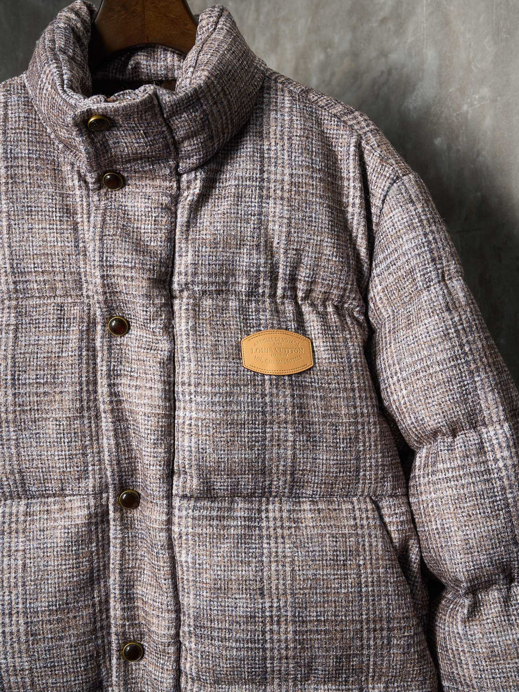 Louis Vuitton long puffer jacket close view of stand collar and tan logo patch