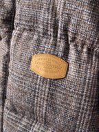 Louis Vuitton long puffer jacket tan brand label on textured fabric panel