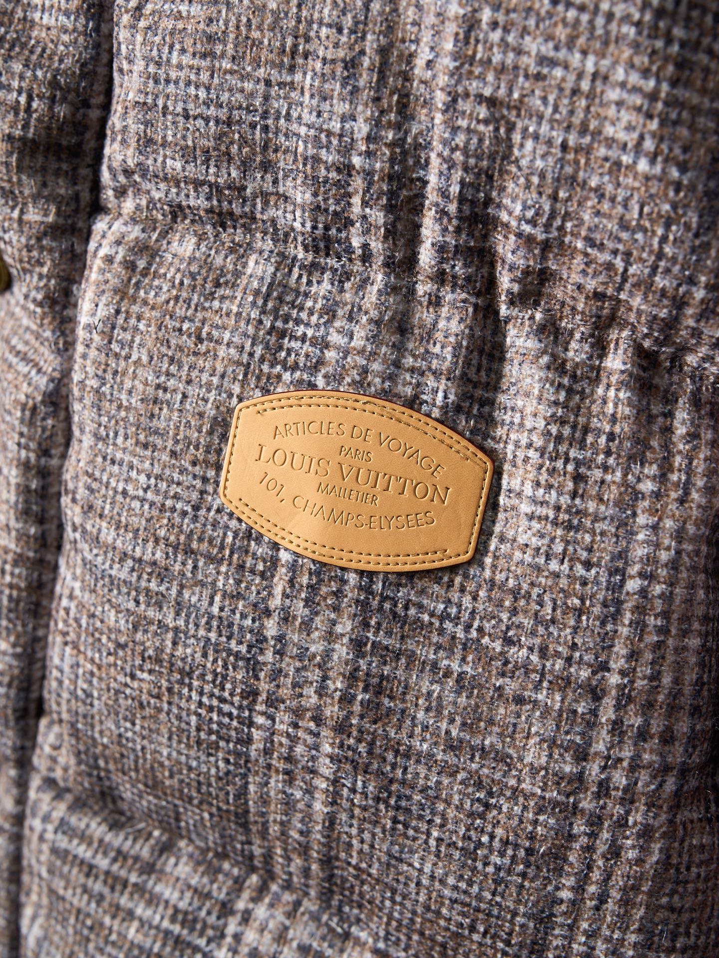 Louis Vuitton long puffer jacket tan brand label on textured fabric panel