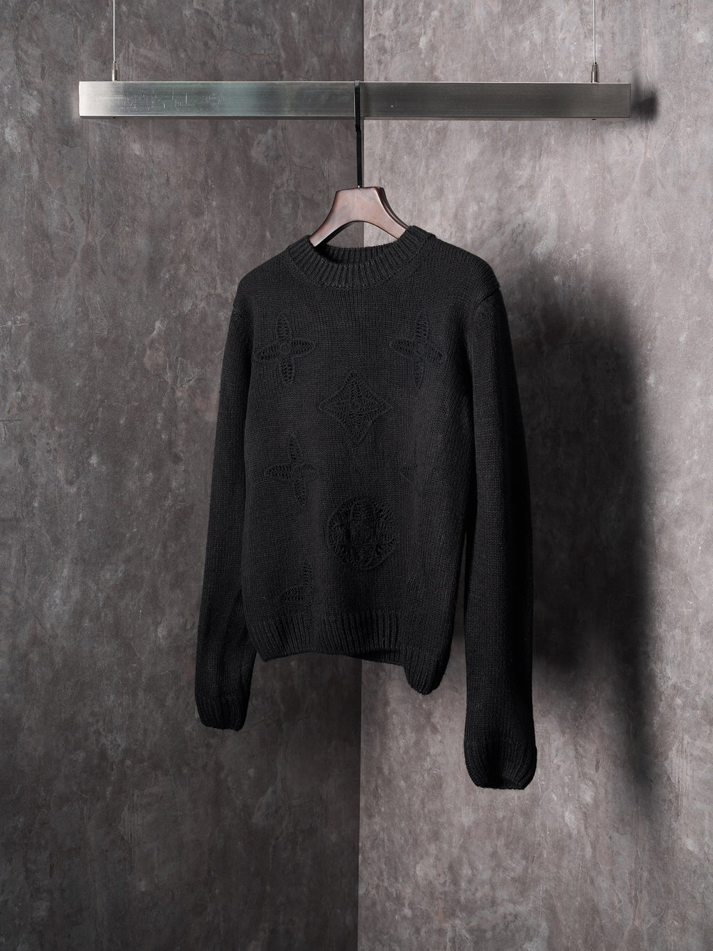 Black long-sleeve knit crewneck sweater with textured monogram motif