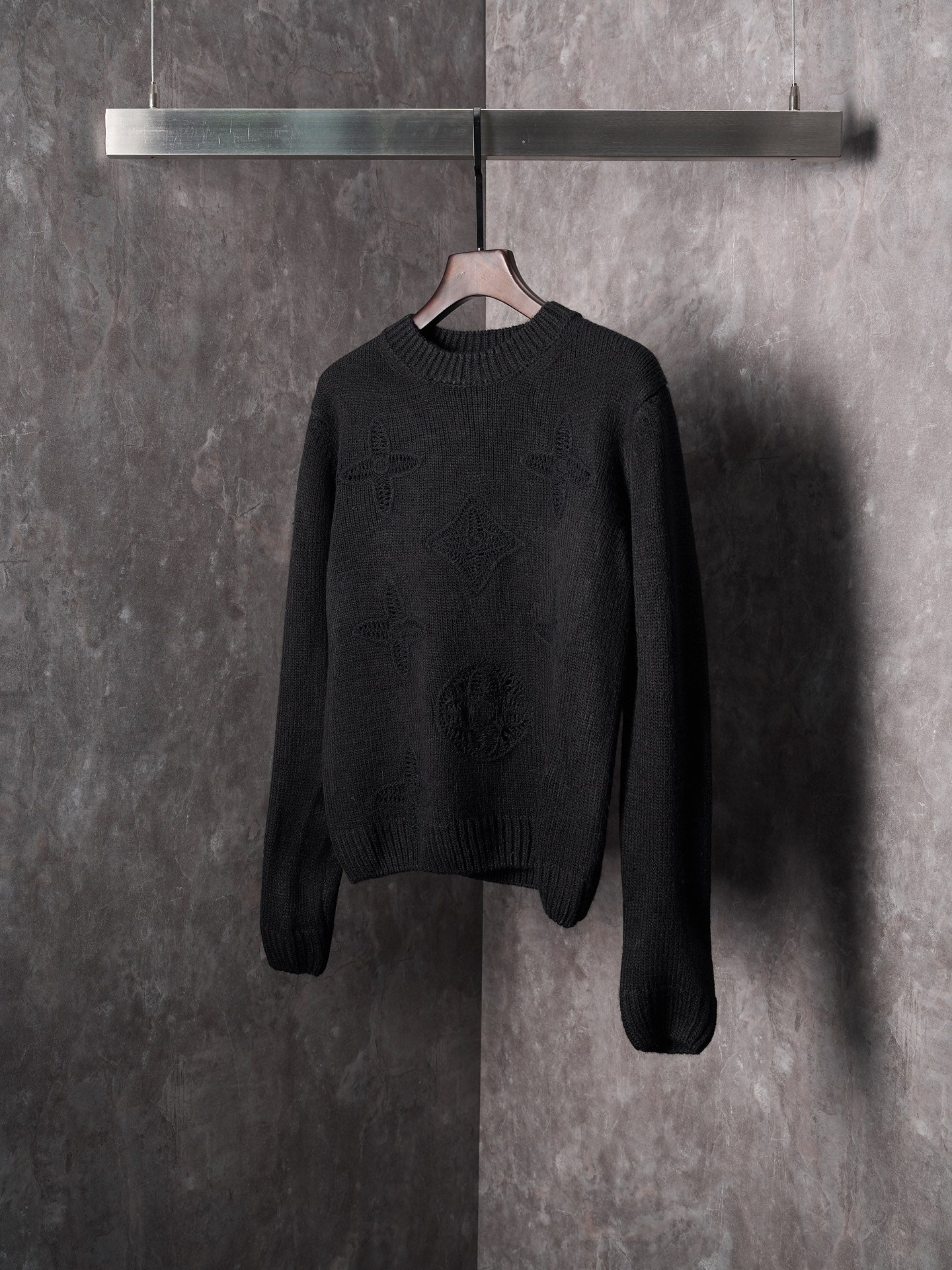 Black long-sleeve knit crewneck sweater with textured monogram motif