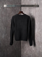 Black knit sweater with crew neck, long sleeves, and allover monogram design