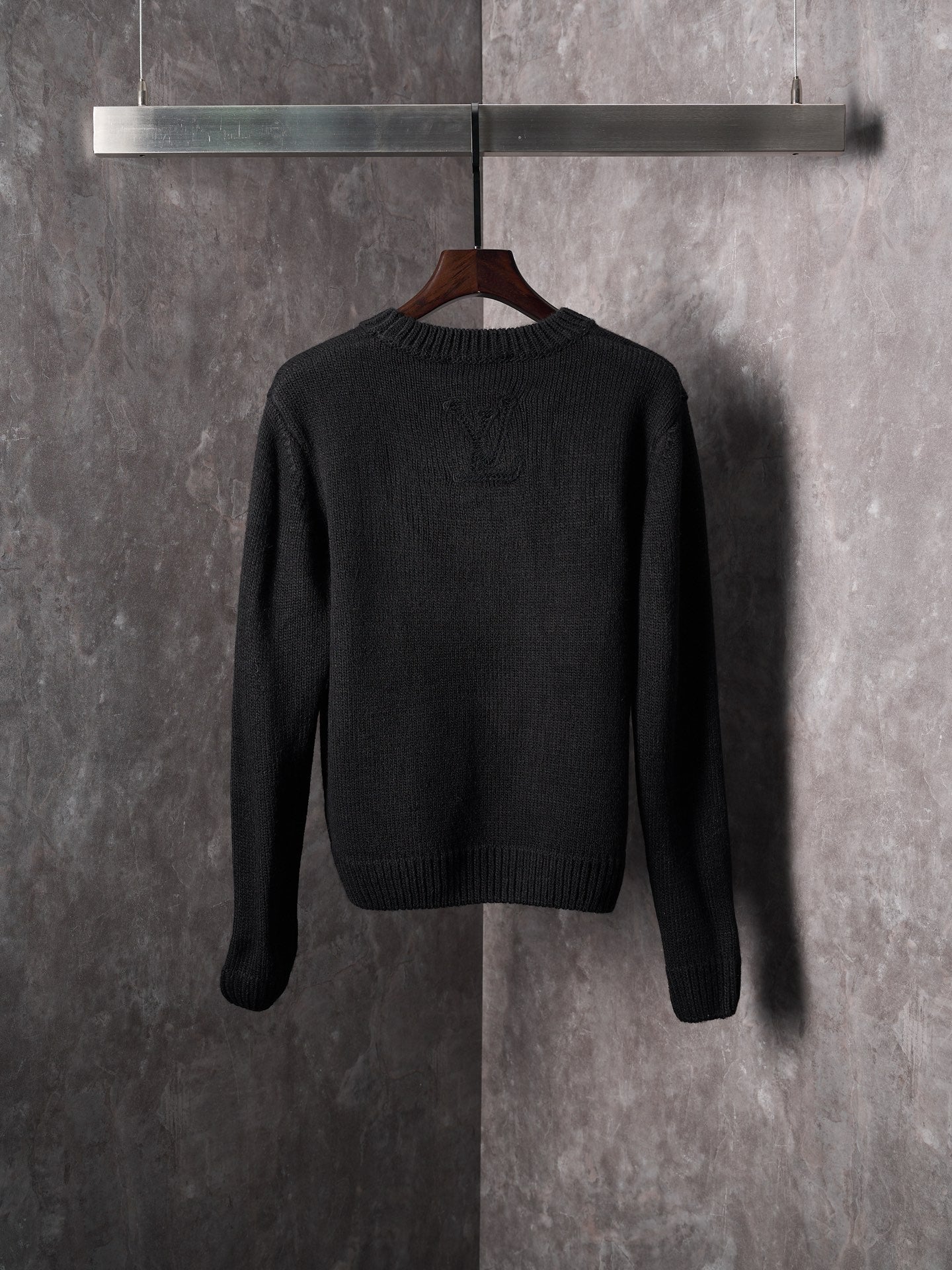 Black knit sweater with crew neck, long sleeves, and allover monogram design