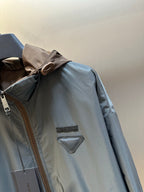 Prada long hooded jacket in light blue with zip front and chest triangle logo patch