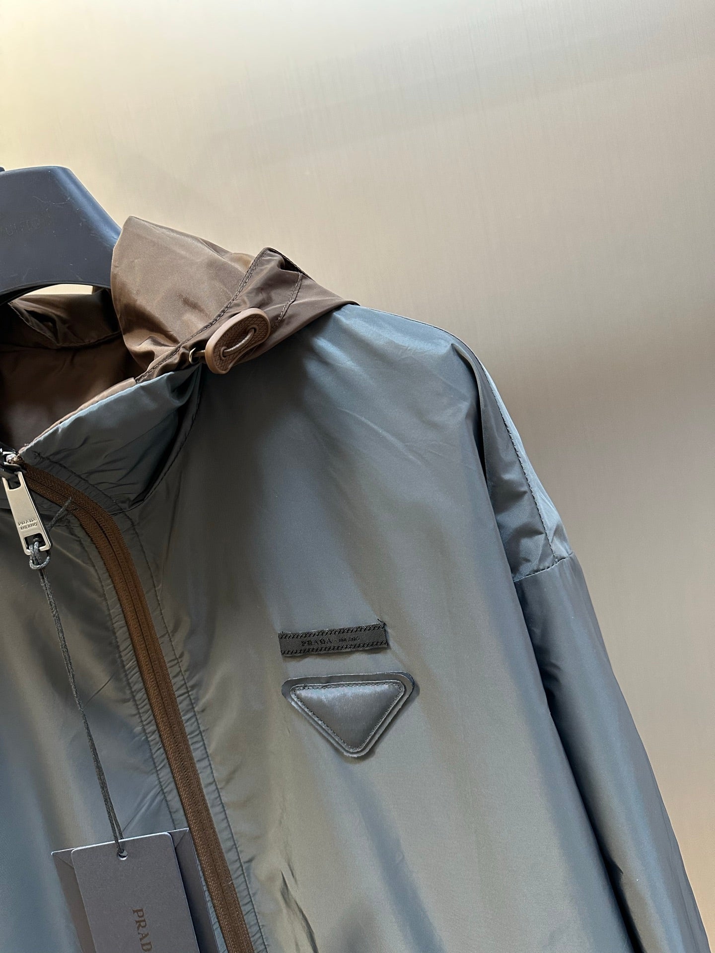 Prada long hooded jacket in light blue with zip front and chest triangle logo patch