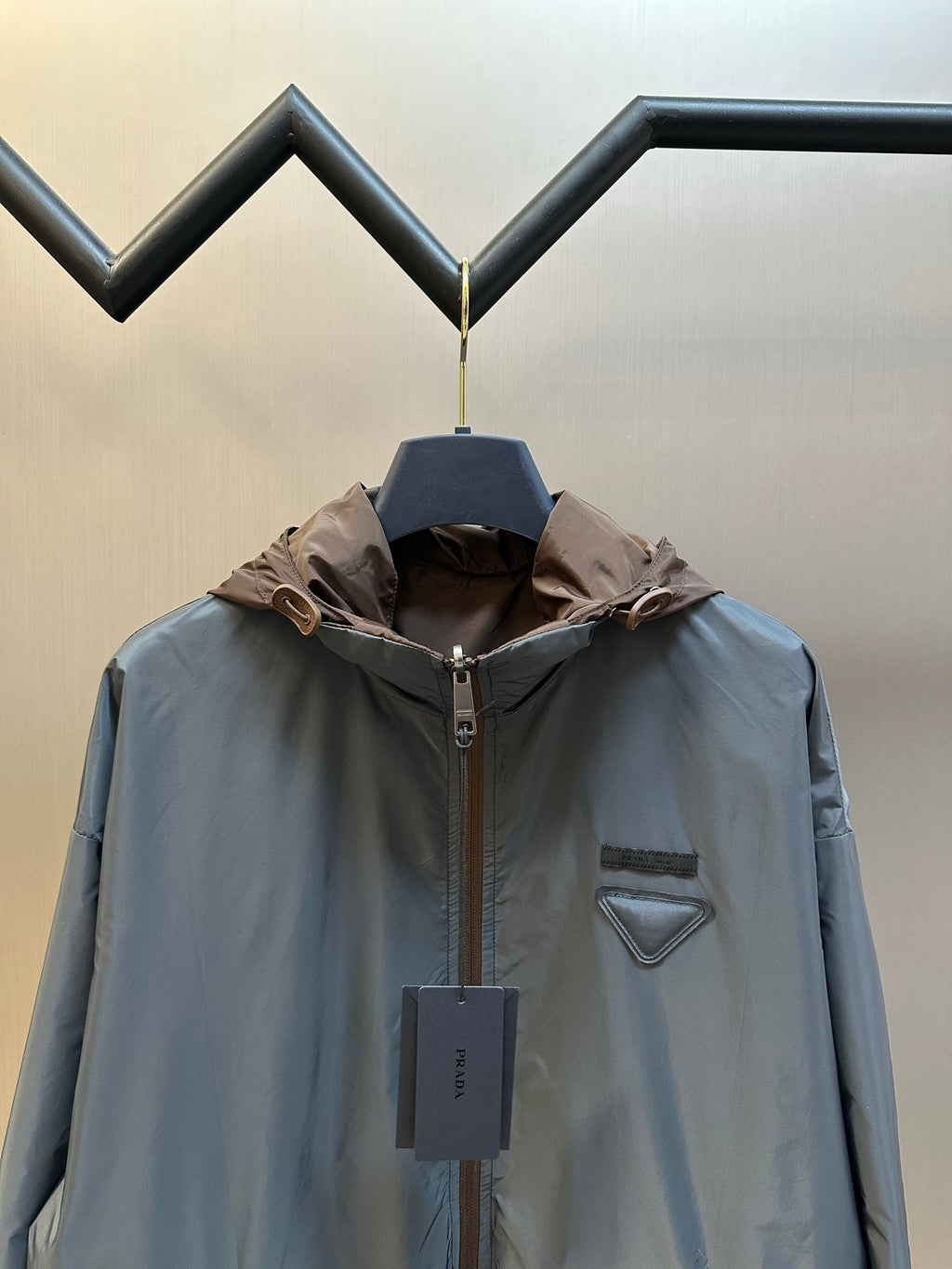 Prada long hooded jacket in light blue with brown hood and chest logo patch