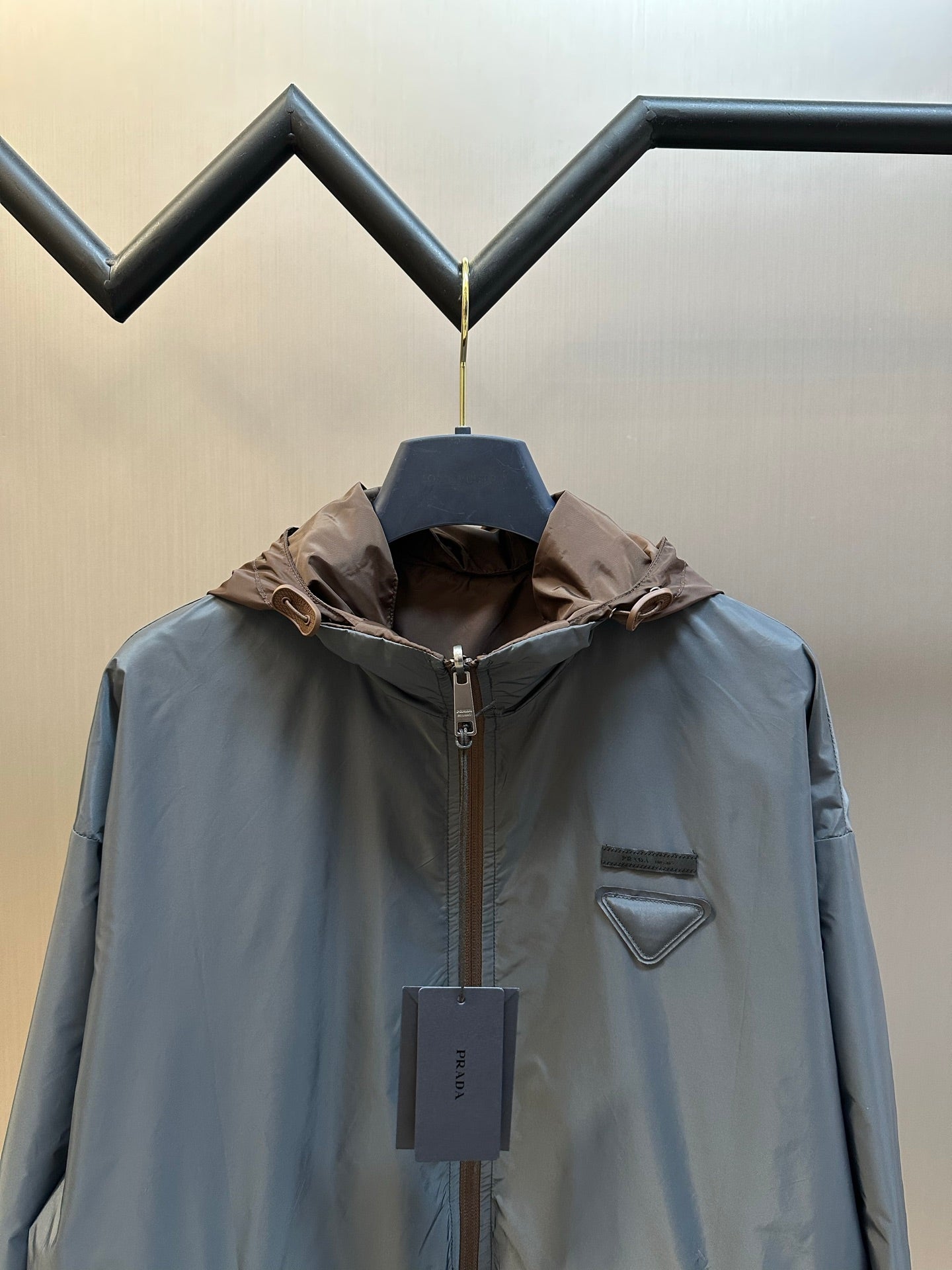 Prada long hooded jacket in light blue with brown hood and chest logo patch
