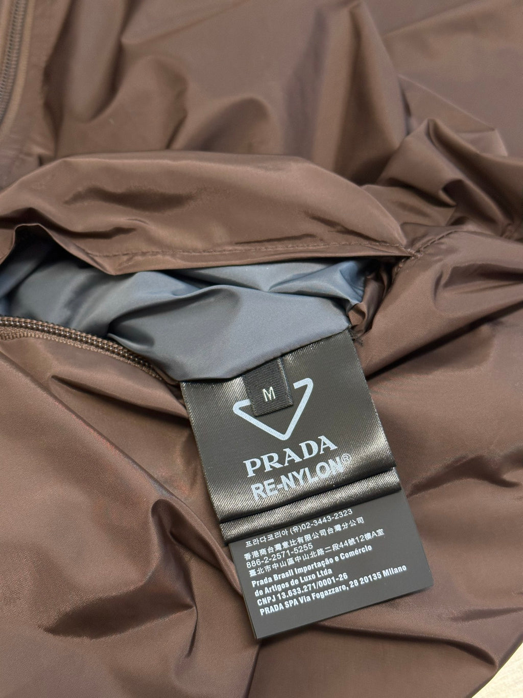 Prada long jacket fabric with inner lining and size brand label tag on seam