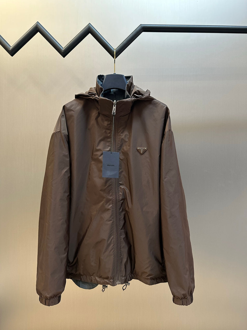 Prada long hooded jacket in dark brown with full front zipper and flap pockets