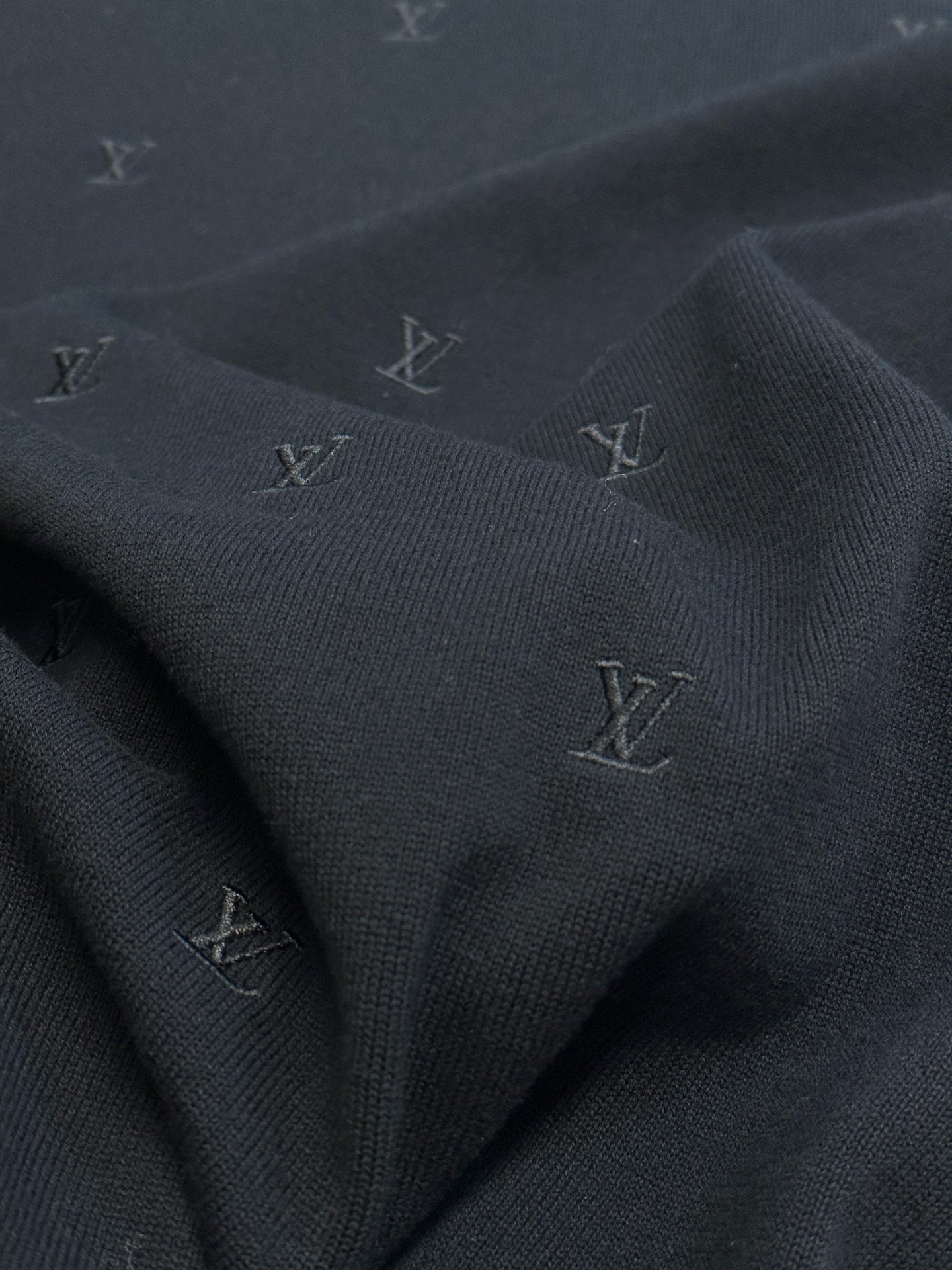 Louis Vuitton dark knit with repeating monogram pattern
