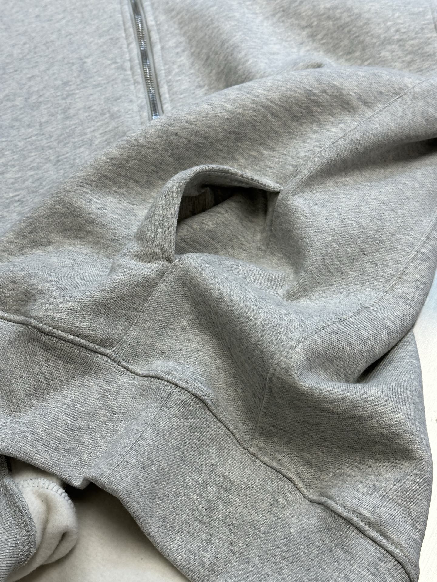 Dior heather gray hoodie sleeve with ribbed cuff and zipper edge