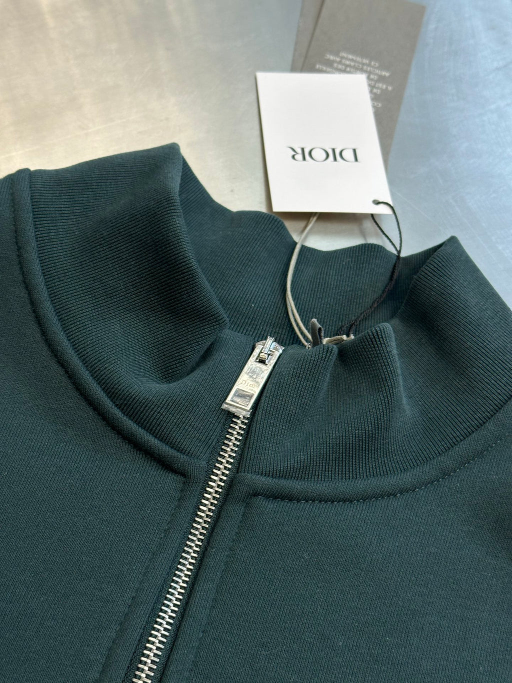 Teal Dior quarter-zip sweatshirt with ribbed collar, front zipper, and logo