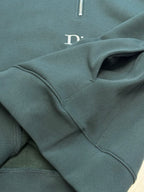 Teal Dior sweatshirt with stitched seam details near logo