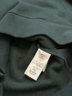 Teal Dior sweatshirt with internal care label on inner collar seam