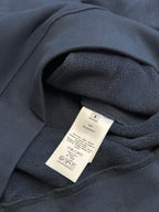 Dark blue Dior hoodie interior with fabric care label in neck area