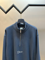 Dark blue Dior quarter-zip hoodie close-up with stand collar and chest logo