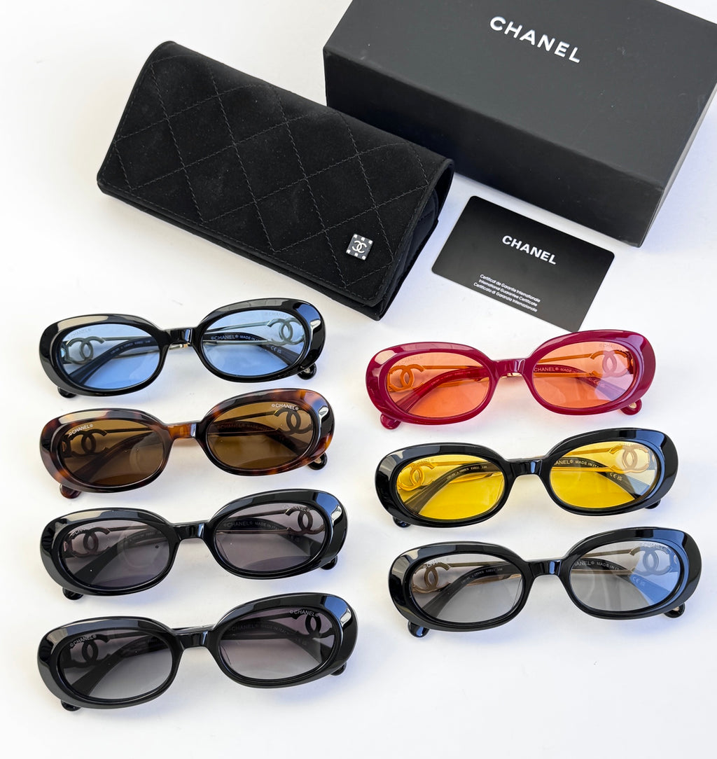 Assorted designer round glasses set with black, brown, red, yellow, and blue frames