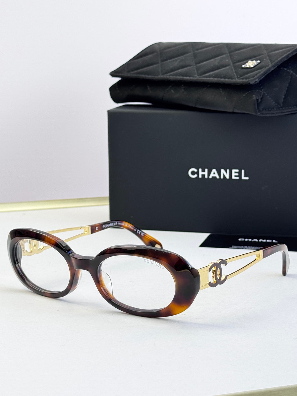 Tortoiseshell oval eyeglasses with gold-tone double-C temple detail