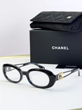 Black oval eyeglasses with gold-tone double-C temple detail