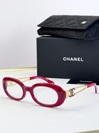 Red round-oval eyeglasses with gold-tone double-C temple detail