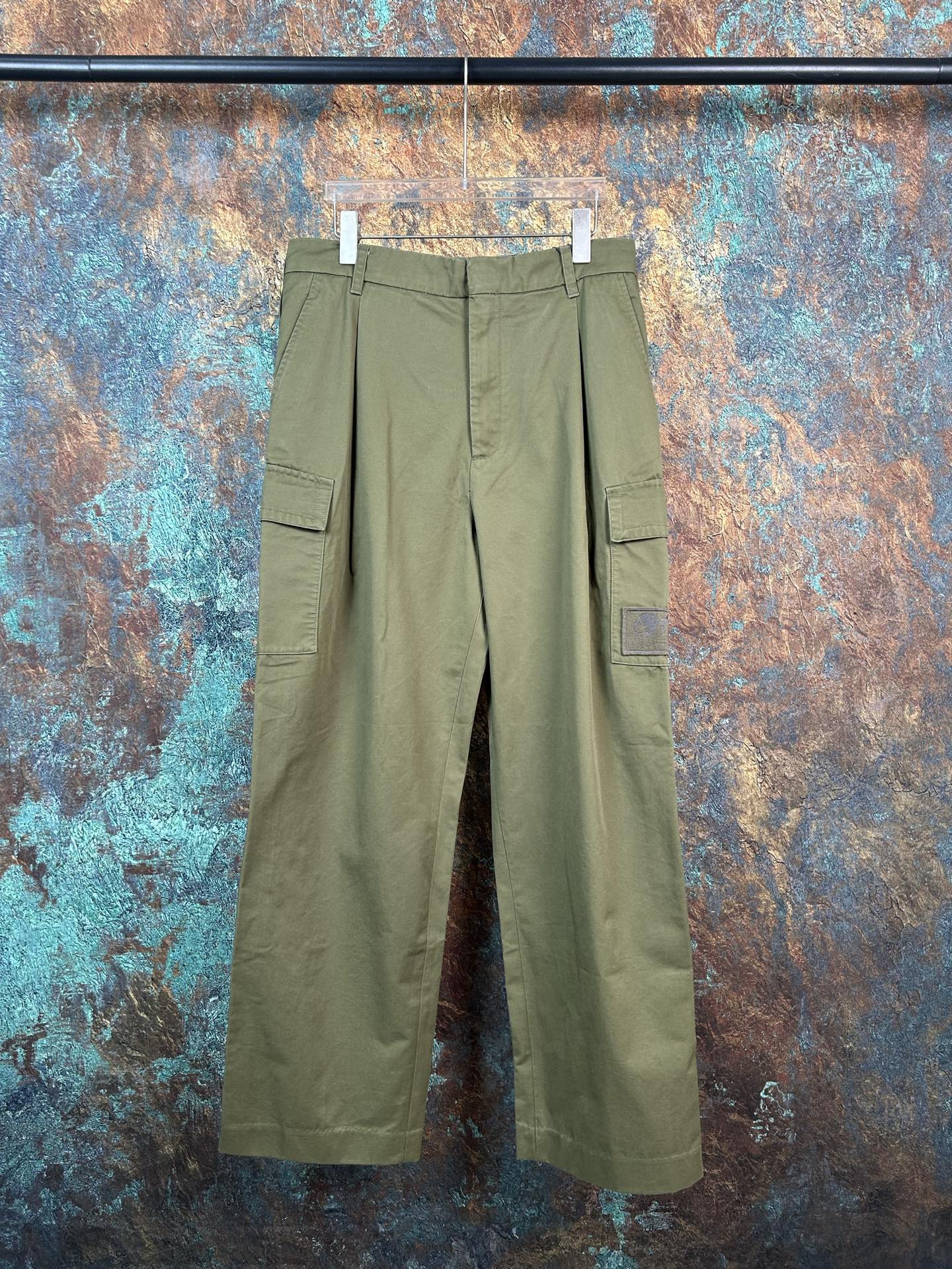 Olive cargo pants with front pleats and flap pockets, straight-leg fit
