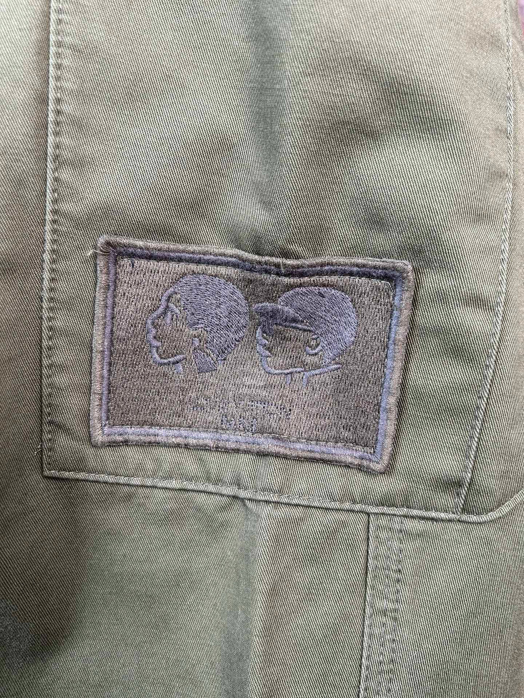 Olive pants pocket with stitched fabric patch detail