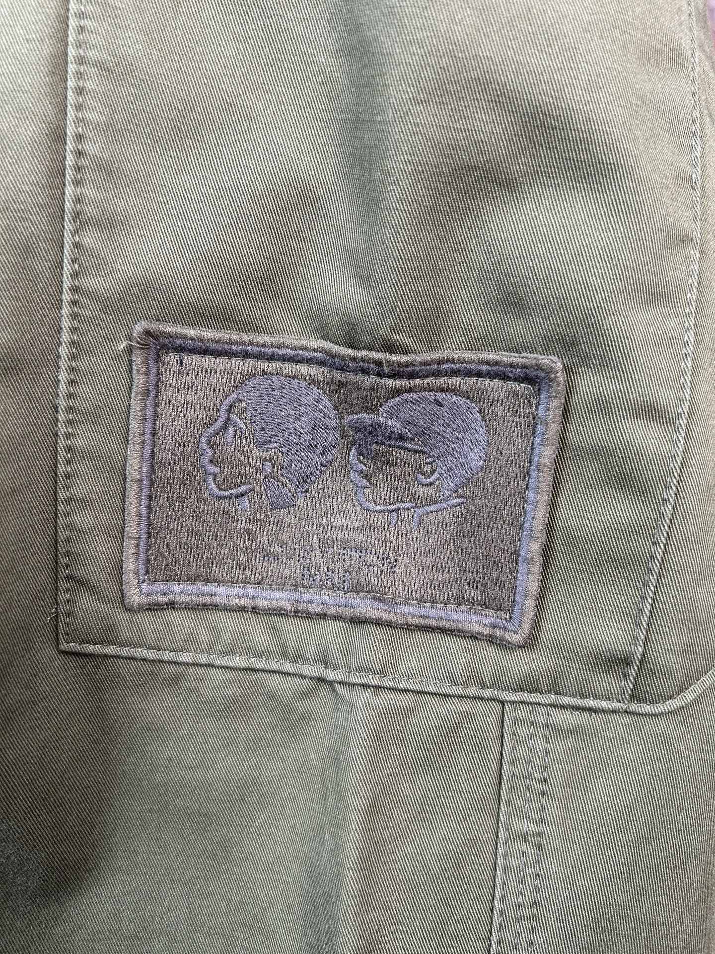 Olive pants pocket with stitched fabric patch detail