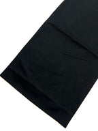 Dark cargo pants hem with clean edge and subtle panel seams