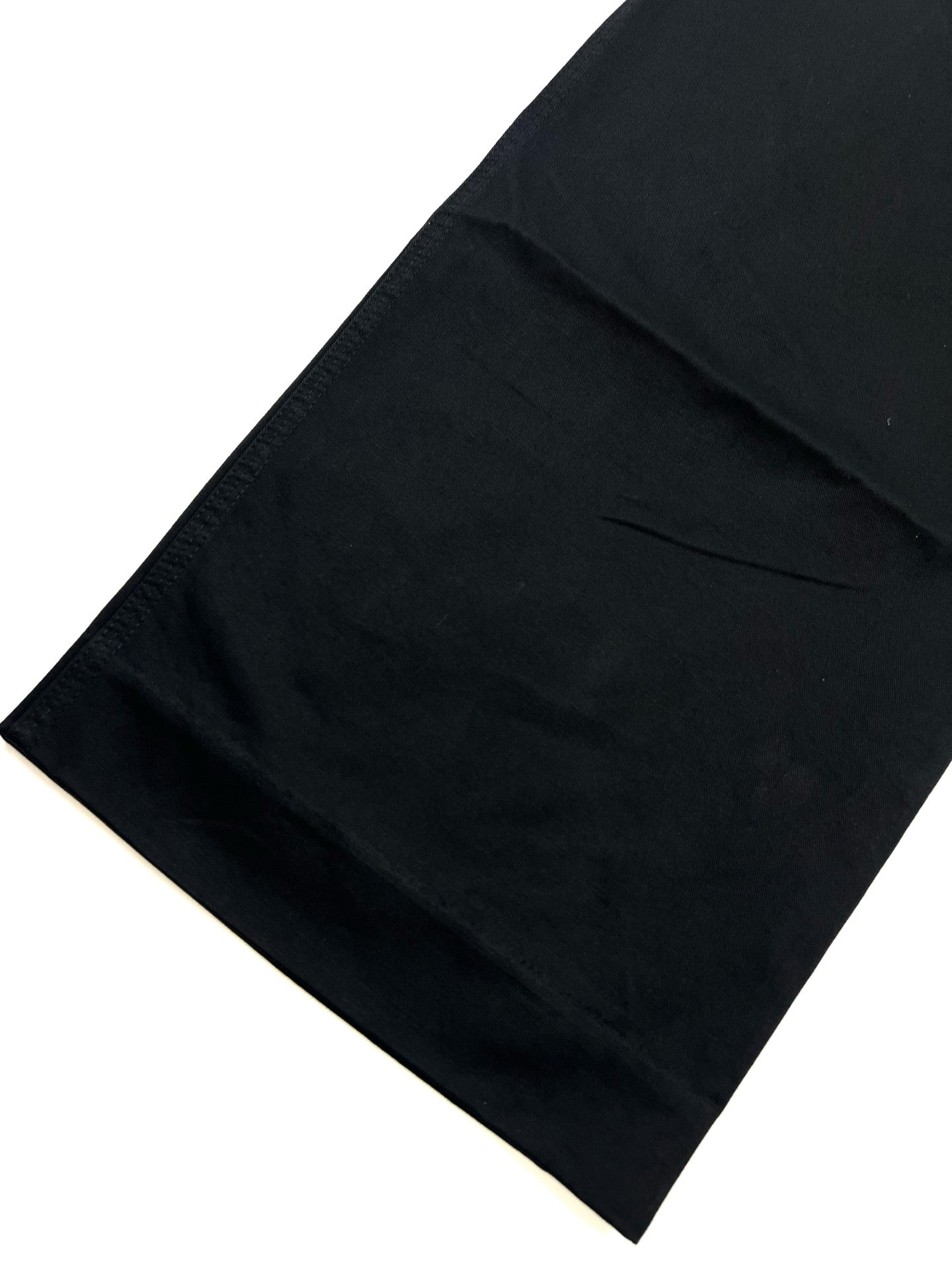 Dark cargo pants hem with clean edge and subtle panel seams