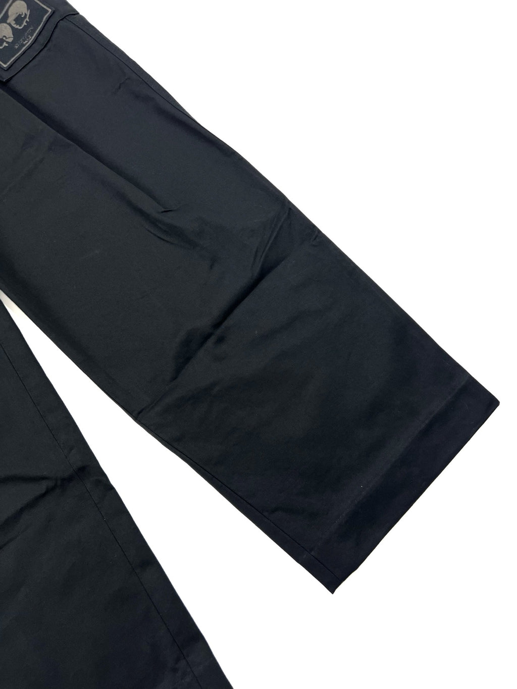 Dark cargo pants leg with side seam and stitched detailing