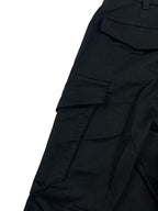 Dark cargo pants with front patch pockets and stitched paneling