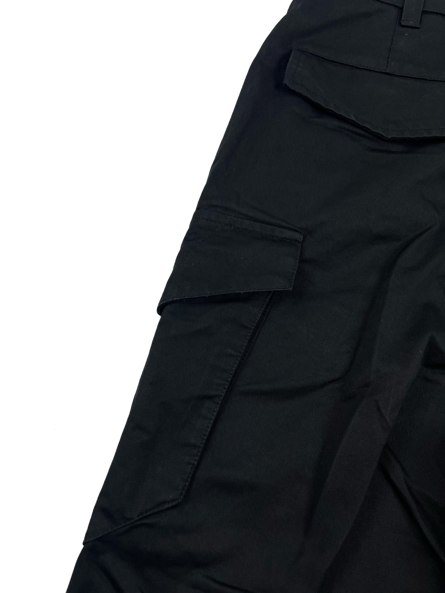 Dark cargo pants with front patch pockets and stitched paneling