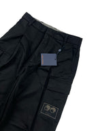 Dark cargo pants waist with belt loops, inner tag, and logo patch on pocket