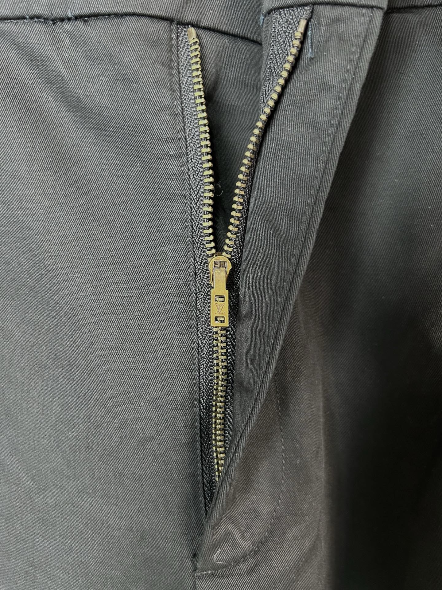 Black cargo pants with gold-tone zipper and button fly