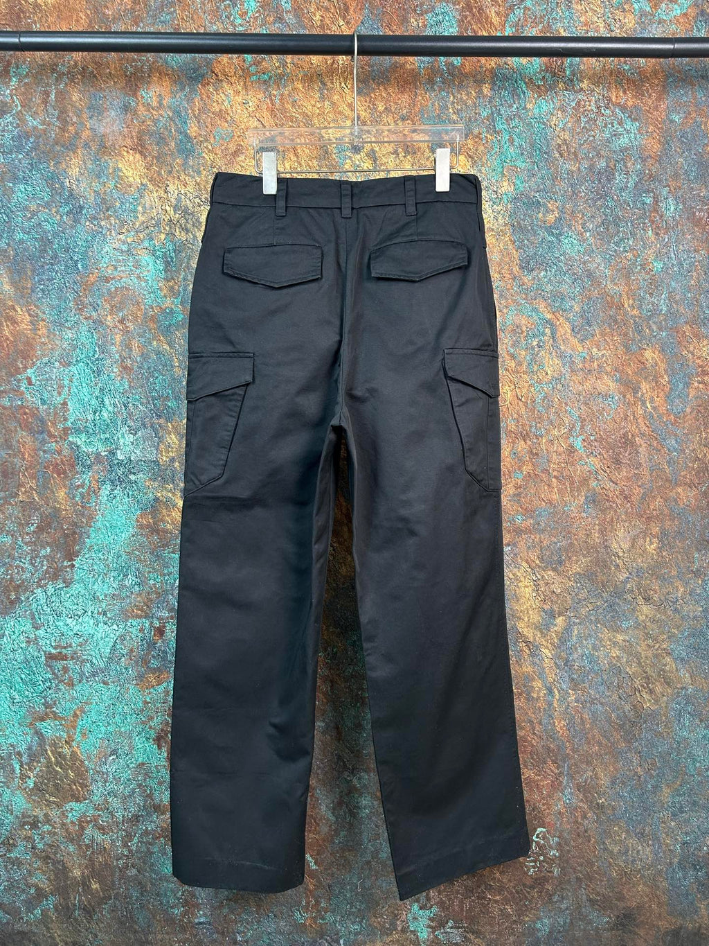 Black cargo pants with front slash pockets and flap side pockets