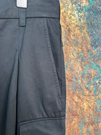 Black cargo pants with pleated front and side seam pockets