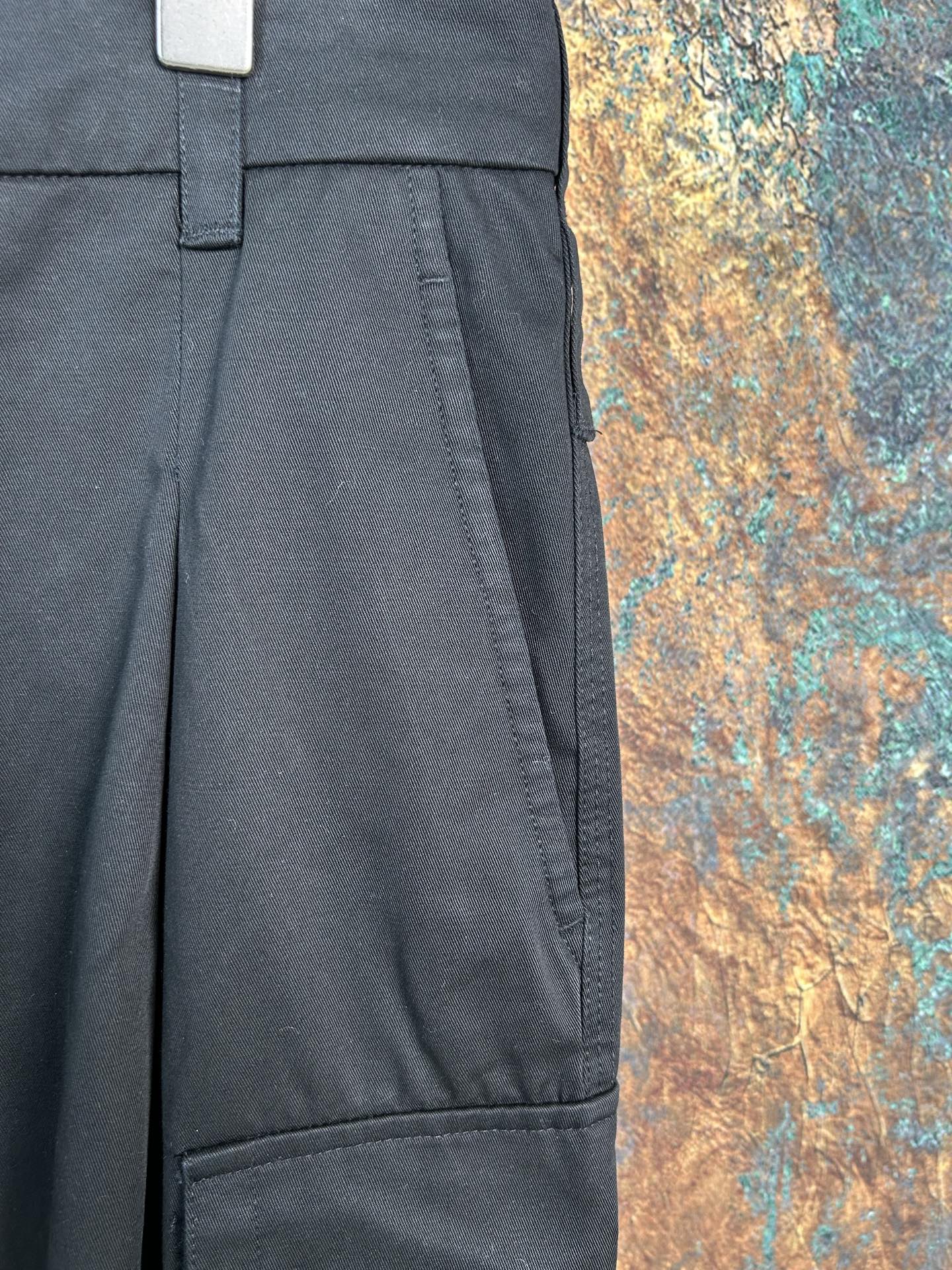 Black cargo pants with pleated front and side seam pockets