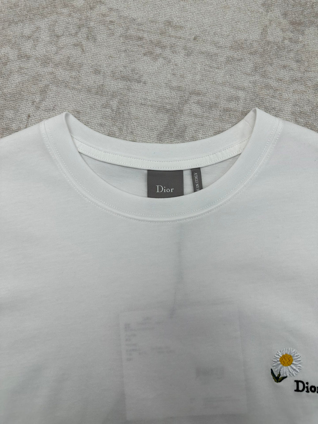 White crewneck T-shirt neckline detail with Dior label inside collar.