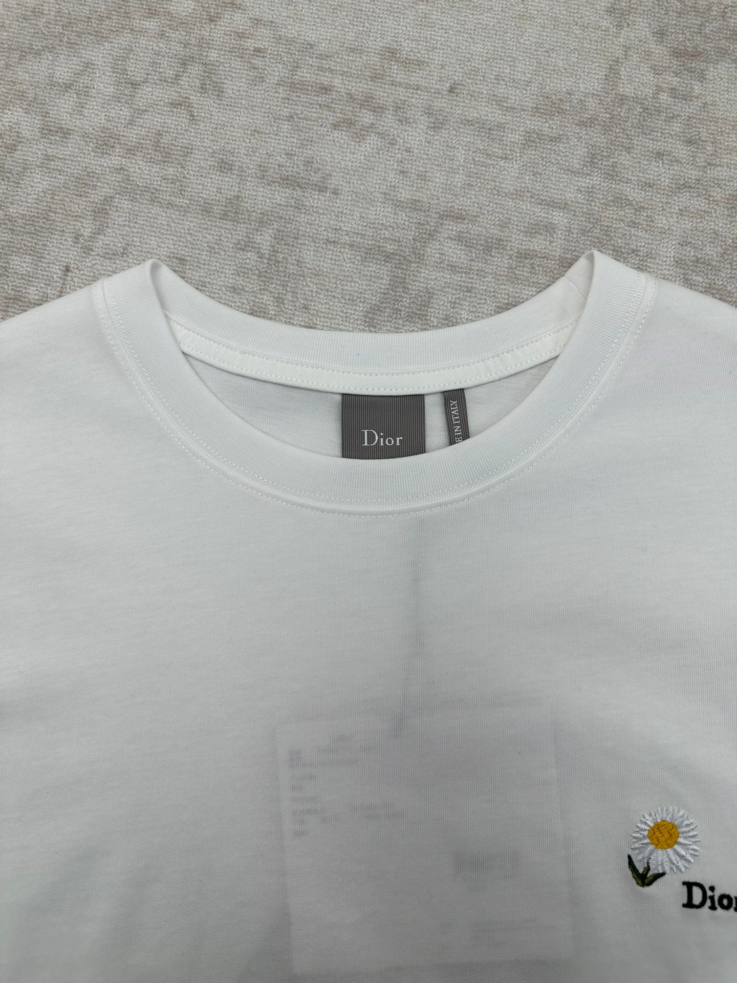 White crewneck T-shirt neckline detail with Dior label inside collar.