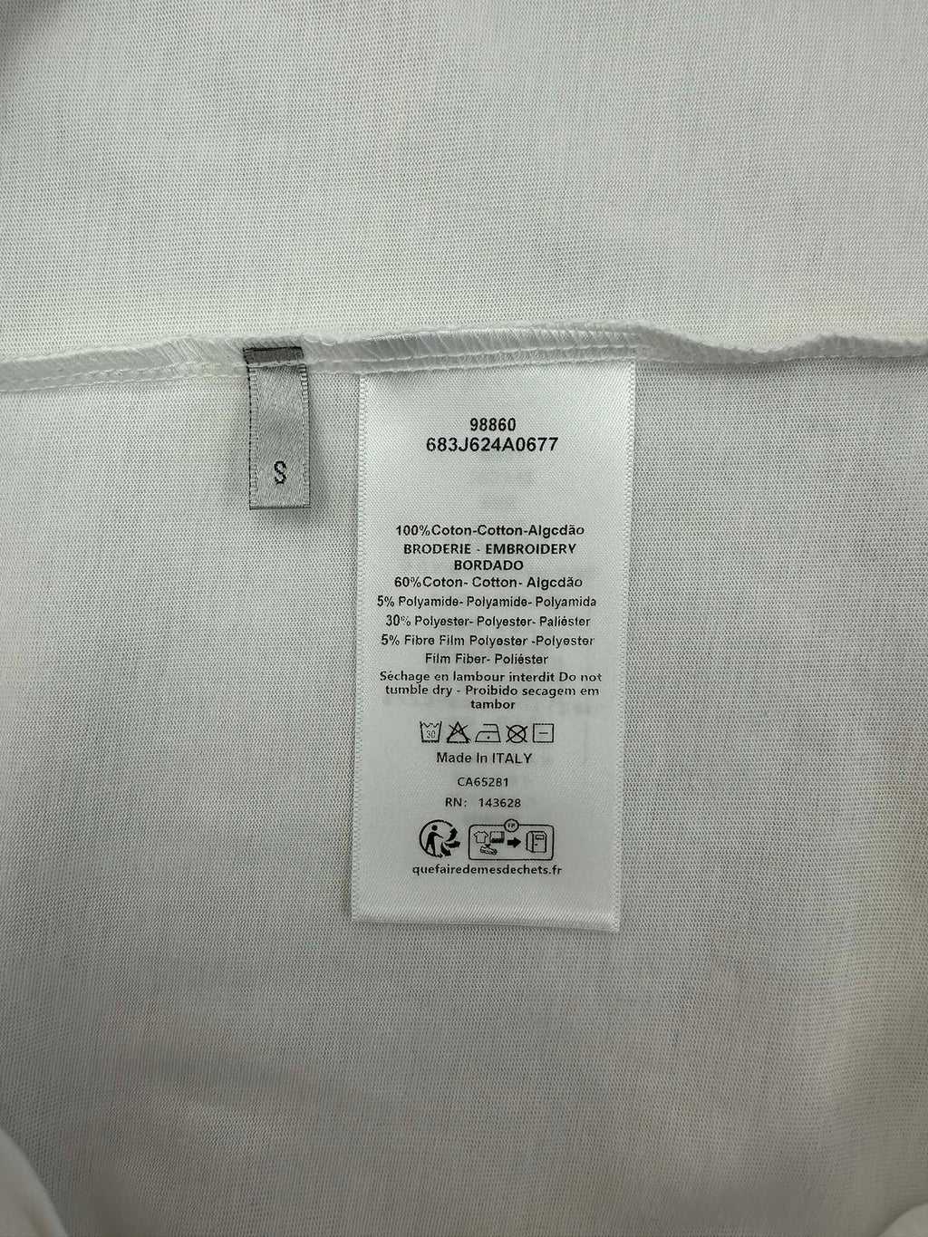 Inside size and care label on white T-shirt.