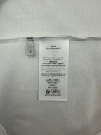 Inside size and care label on white T-shirt.