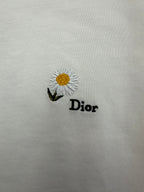 White T-shirt with daisy embroidery and "Dior" text logo on front.