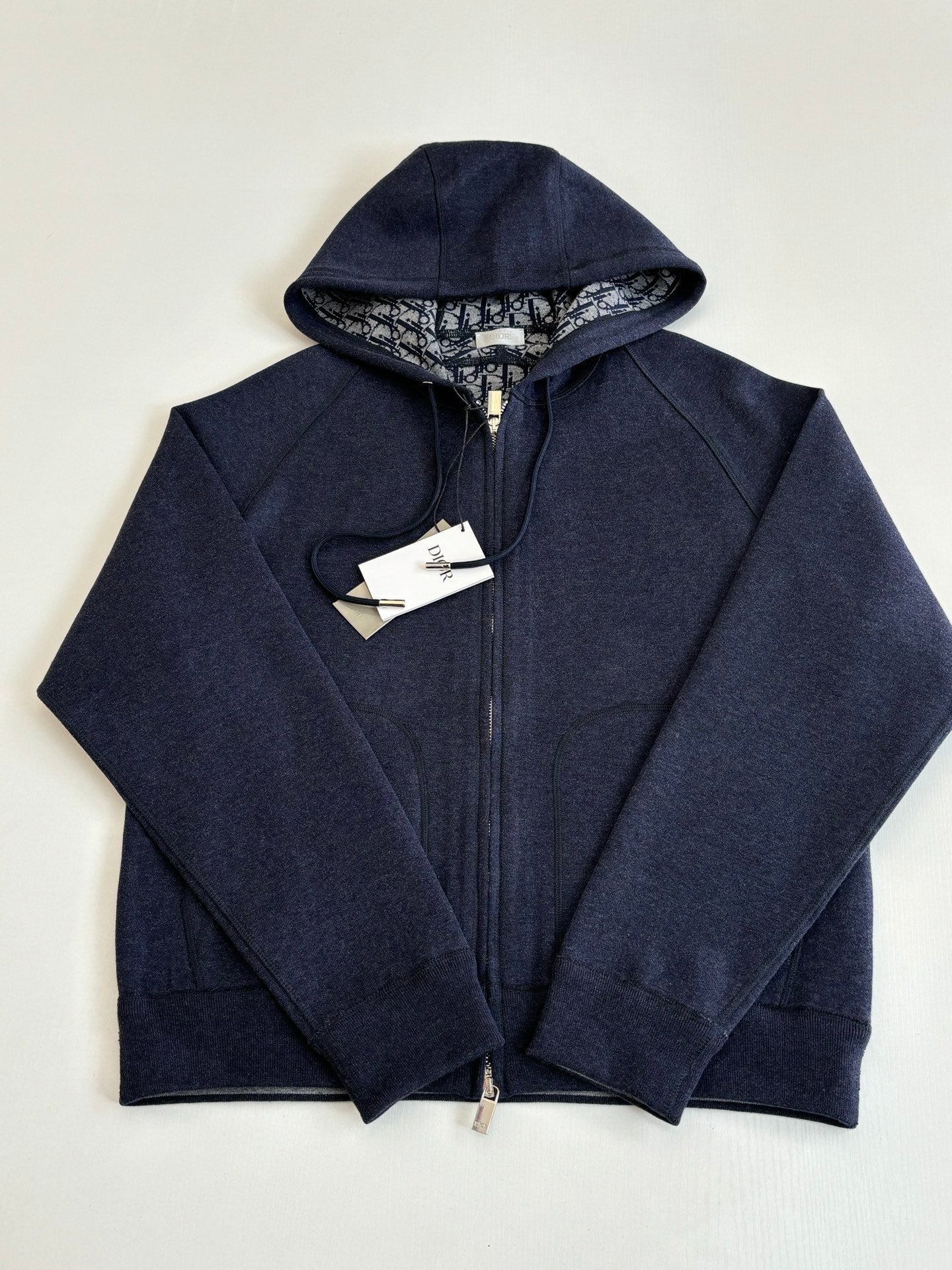 Dior navy zip-up hoodie with hood, front view on display