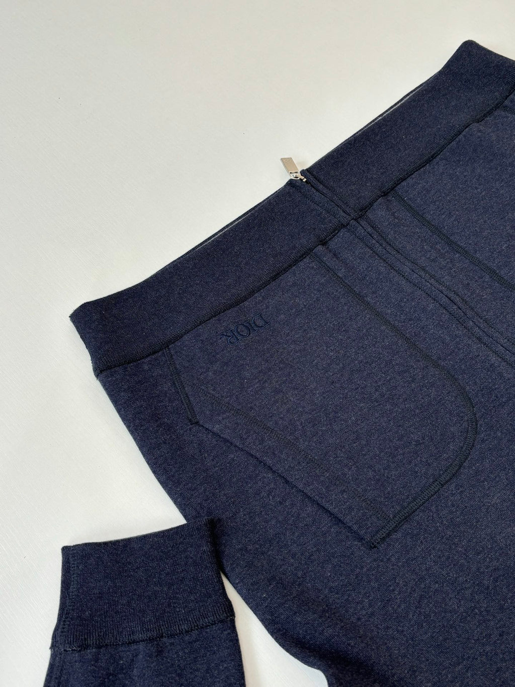 Dior navy hoodie with ribbed cuffs and kangaroo pocket, side view