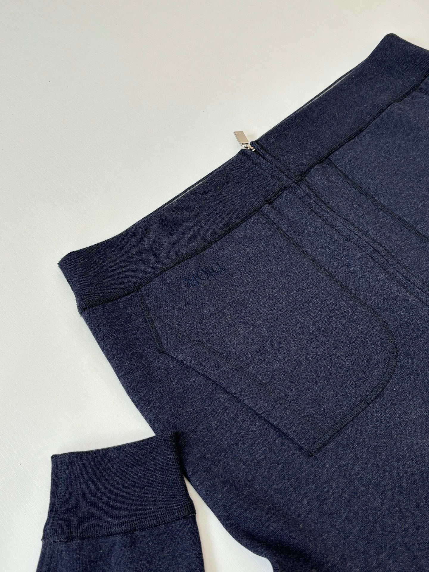 Dior navy hoodie with ribbed cuffs and kangaroo pocket, side view