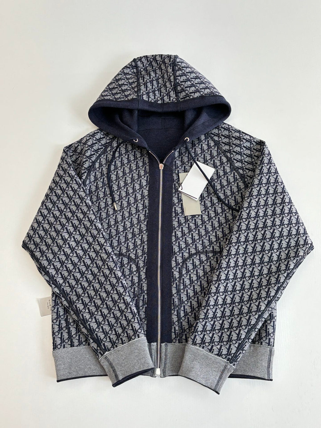 Dior hoodie with dark pattern hood lining and gray ribbed cuffs