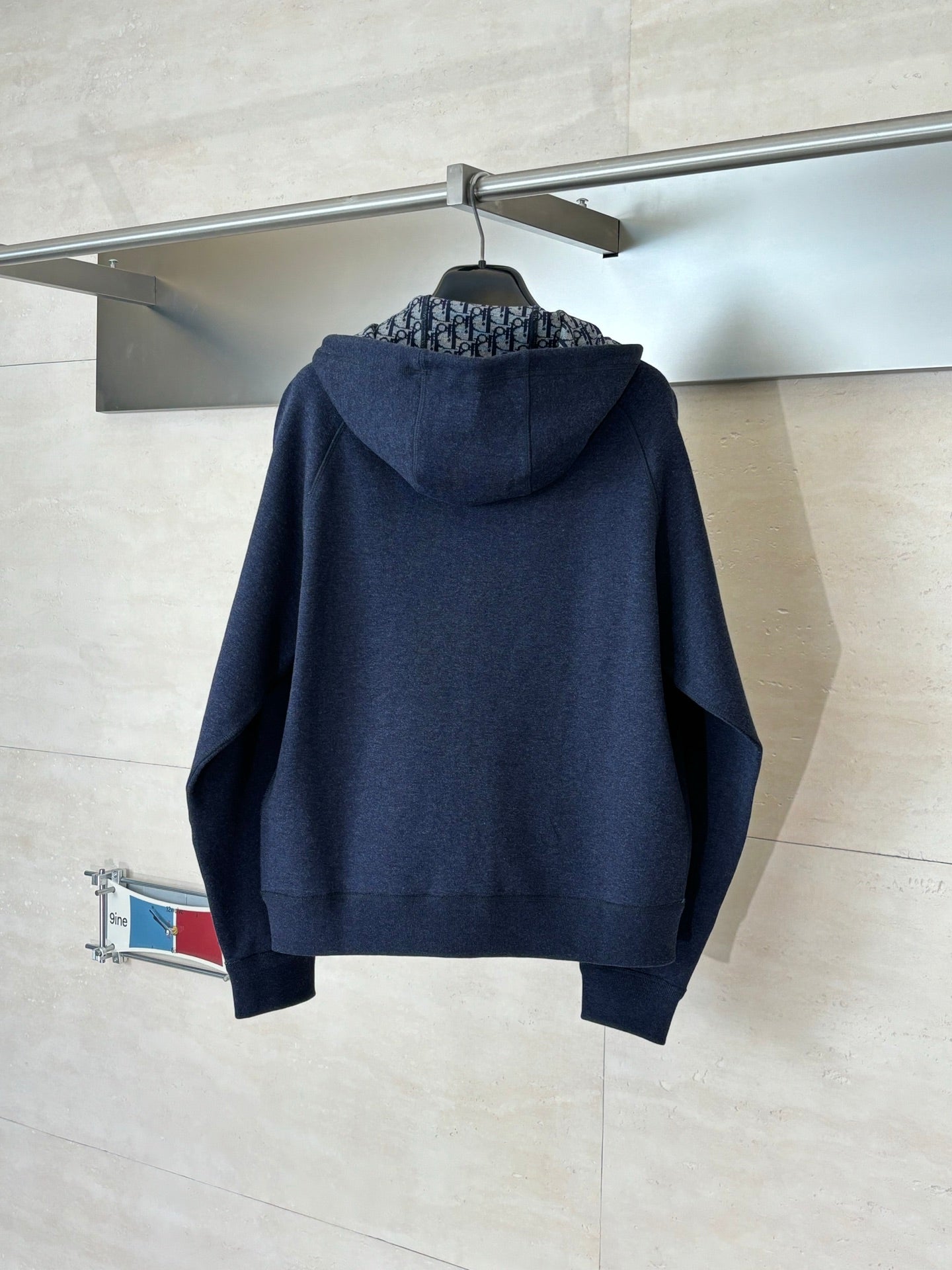 Dior navy zip-up hoodie with hood and ribbed hem, back view