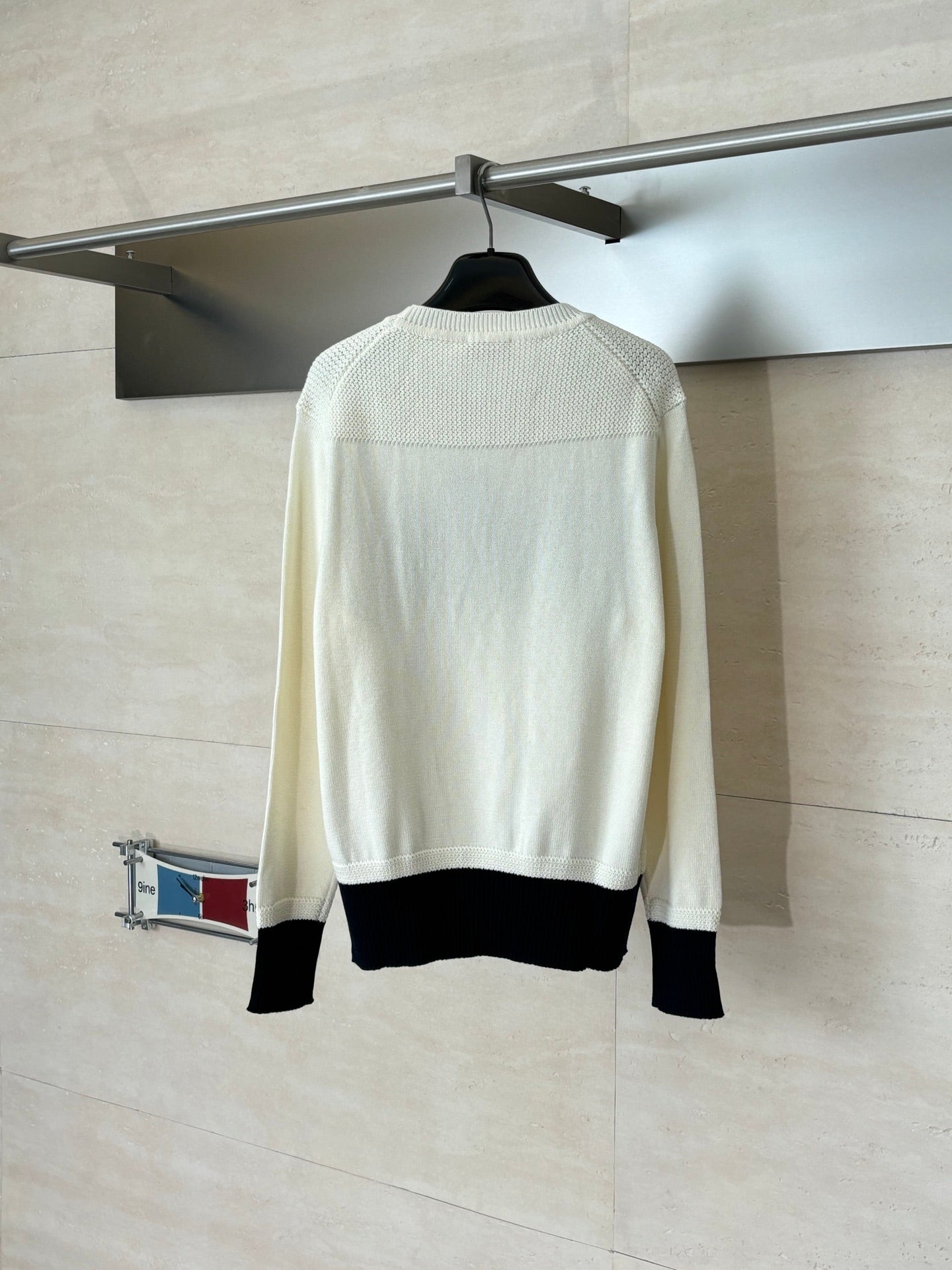 Dior crewneck sweater back view in cream with black ribbed hem and cuffs